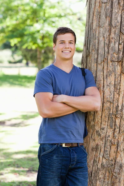 Portrait of a muscled student next to a tree — Stock Photo, Image