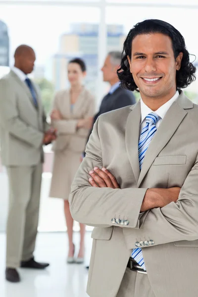 Young businessman standing upright while crossing his arms — Stock Photo, Image