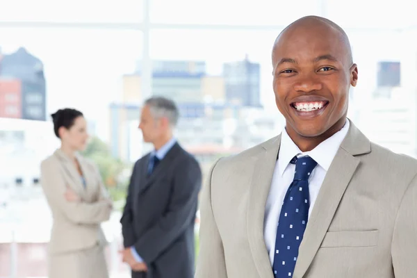 Young manager standing upright while smiling — Stock Photo, Image