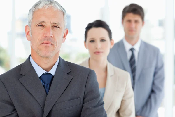 Ernstige en volwassen manager staande rechtop voor zijn team — Stockfoto