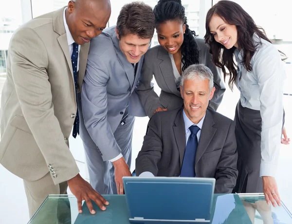 Four business attentively listening to their mature manag — Stock Photo, Image