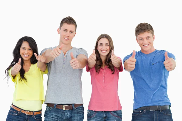 Four standing beside each other give thumbs up — Stock Photo, Image
