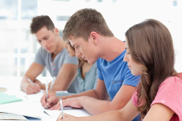 Side view of four students working together — Stock Photo, Image