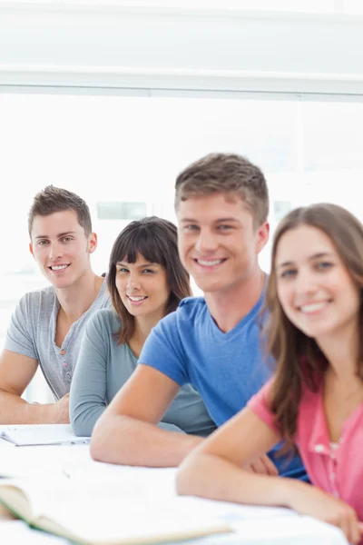 Close up side view of smiling students looking at the camera — Stock Photo, Image