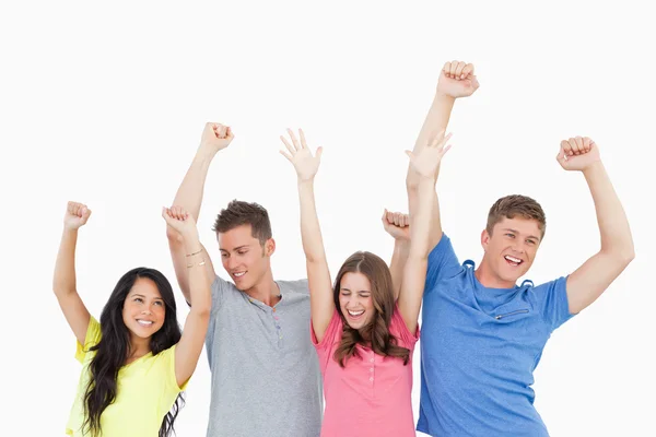 Four friends party together with hands in the air Stock Picture