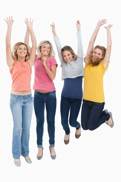 Smiling celebrating girls jumping up — Stock Photo, Image