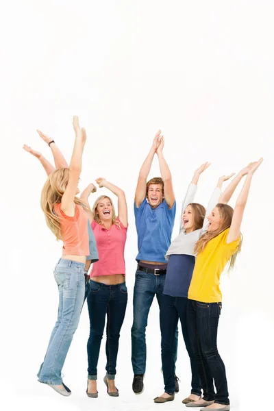 Group of friends cheering as they jump in the air and look at on — Stock Photo, Image