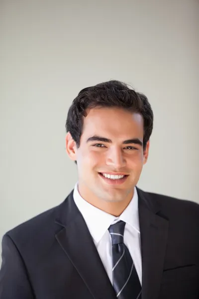 Businessman standing while smiling — Stock Photo, Image