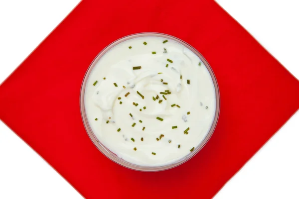 Bowl of dip with herbs on a red napkin — Stock Photo, Image