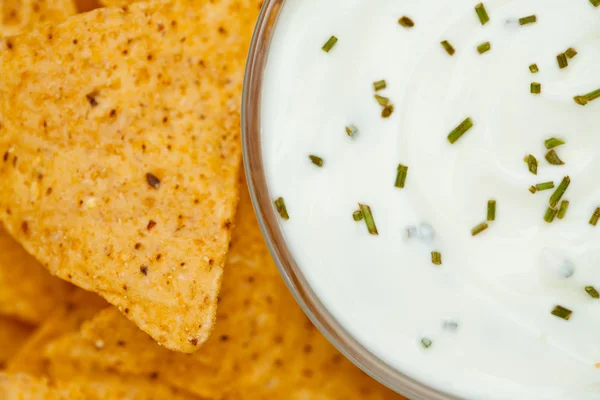 Feche uma tigela de molho branco ao lado de nachos — Fotografia de Stock