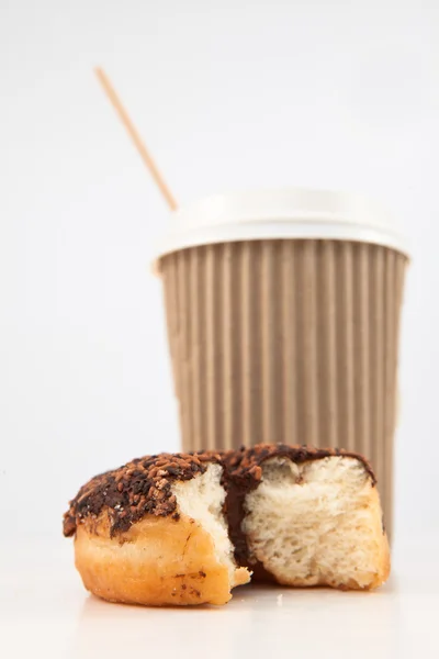 Um donut meio comido e uma xícara de café colocados juntos — Fotografia de Stock