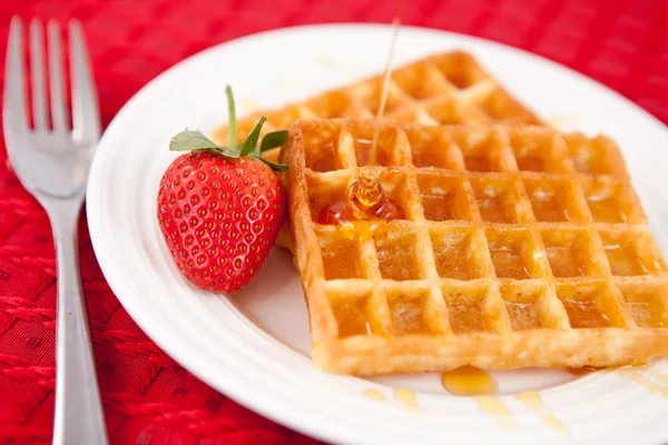Waffles and syrup and strawberry together in a white plate — Stock Photo, Image