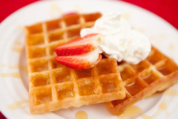 Waffles with whipped cream and strawberry and syrup — Stock Photo, Image