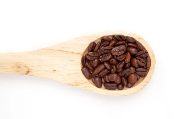 Wooden spoon with coffee seeds — Stockfoto