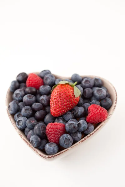 Fruits in a heart shaped bowl — Stock Photo, Image