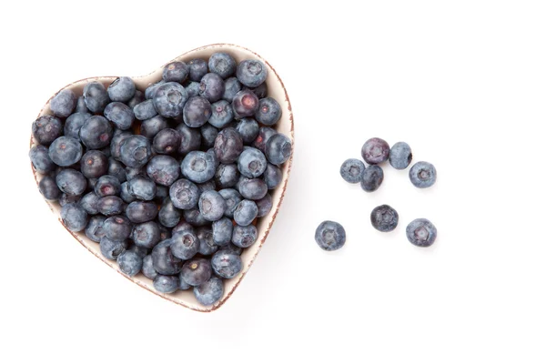 Fresh blueberries in a heart shaped bowl — Stock Photo, Image