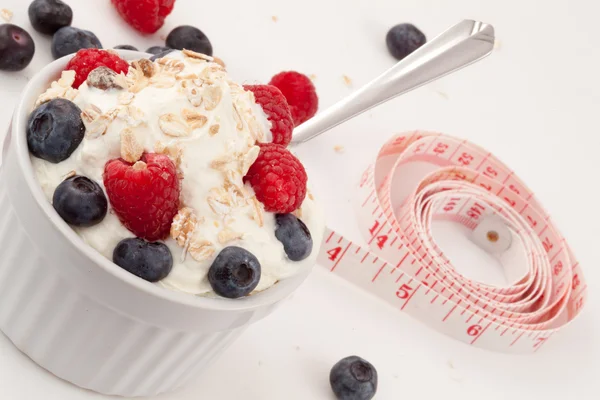 Jar of fruits and whipped cream with spoon and tape measure — Stock Photo, Image