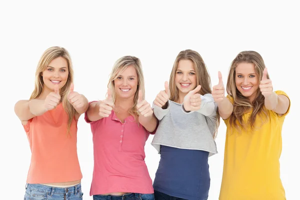 Girls sticking their thumbs up Royalty Free Stock Images