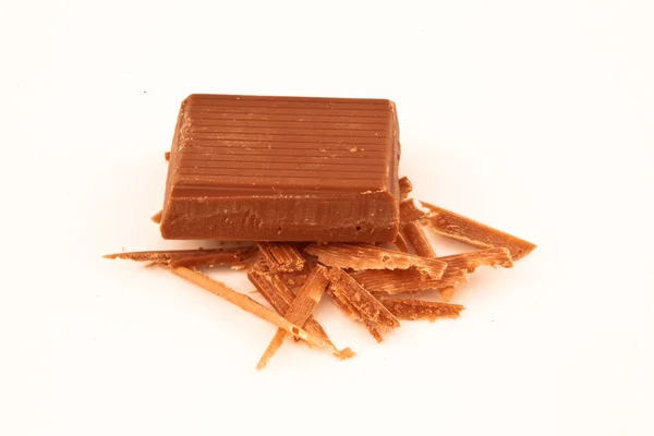 Pedazo de chocolate con leche en virutas de chocolate —  Fotos de Stock