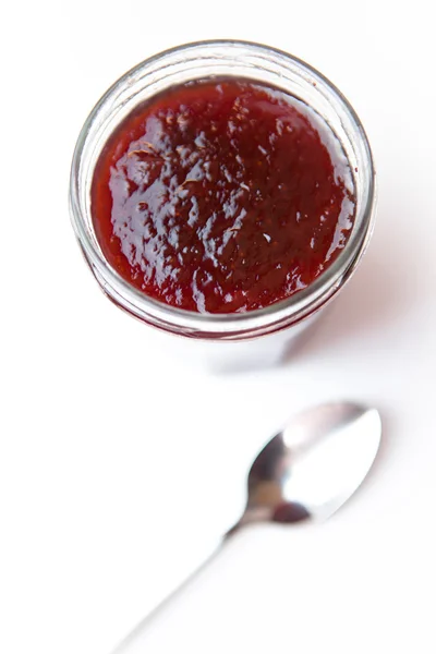 Jar of jam and spoon — Stock Photo, Image
