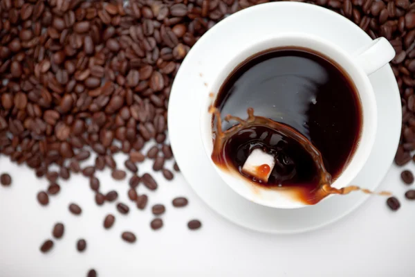 Cup of coffee with beans — Stock Photo, Image