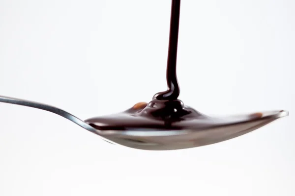 Spoon with chocolate — Stock Photo, Image