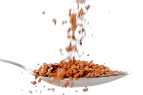 Chocolate powder falling in a spoon — Stock Photo, Image