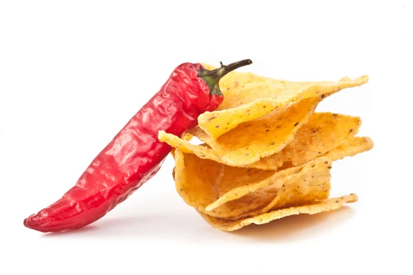 Pepper beside a small stack of crisps — Stock Photo, Image