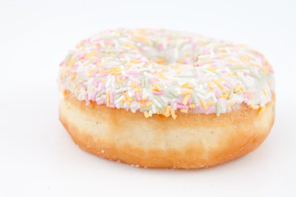 Close up of a doughnut with multi coloured icing sugar — Stock Photo, Image