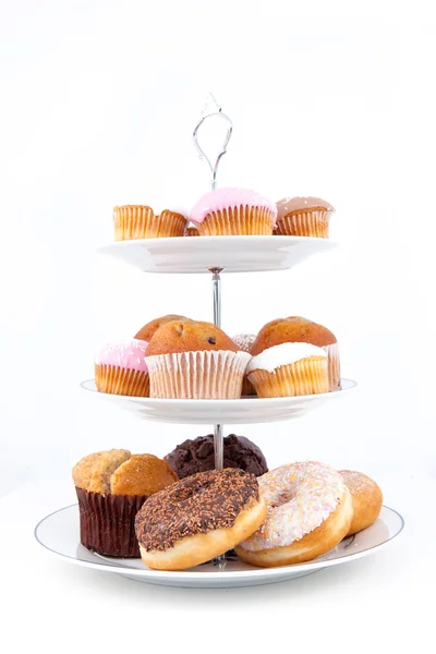 Many cakes placed on three white plates — Stock Photo, Image