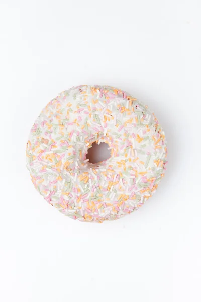 Extremo close-up de um donut com açúcar de confeiteiro multi colorido — Fotografia de Stock