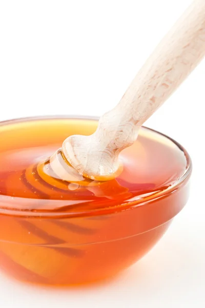 Close up of a honey bowl with a honey dipper — Stock Photo, Image