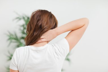 Woman massaging her neck clipart