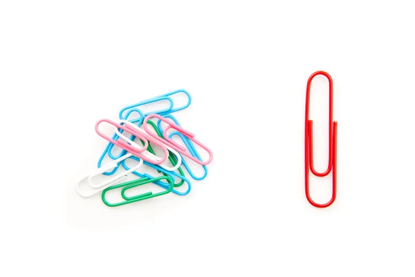 Big red paper clip and many paper clips side by side — Stock Photo, Image