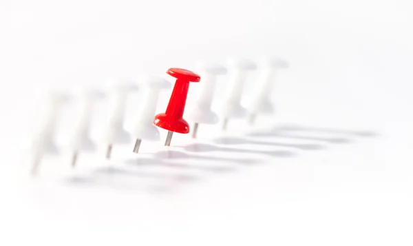 Red push pin in the middle of white push pins — Stock Photo, Image