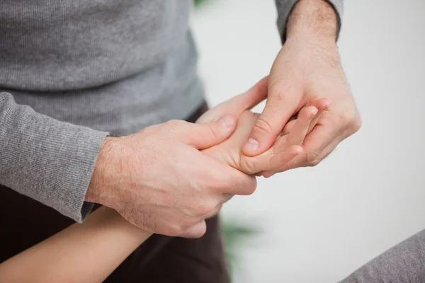 Physiotherapist massaging a hand — Stock Photo, Image