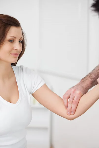 Close-up of a smiling woman being examined by a doctor — Stock Photo, Image