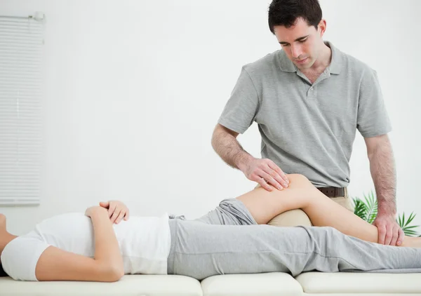 Woman lying on her back while being massaged — Stock Photo, Image