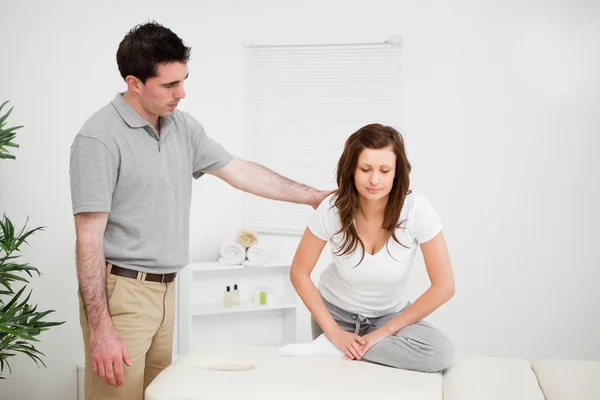 Peaceful woman doing stretching exercises with a doctor — Stock Photo, Image