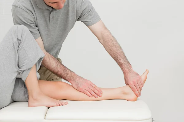 Calf of a patient being stretched by a doctor — Stock Photo, Image
