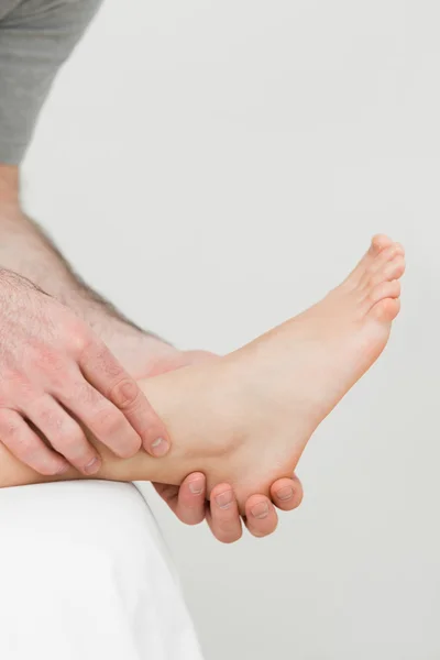 Ball of a foot being held by a practitioner — Stock Photo, Image