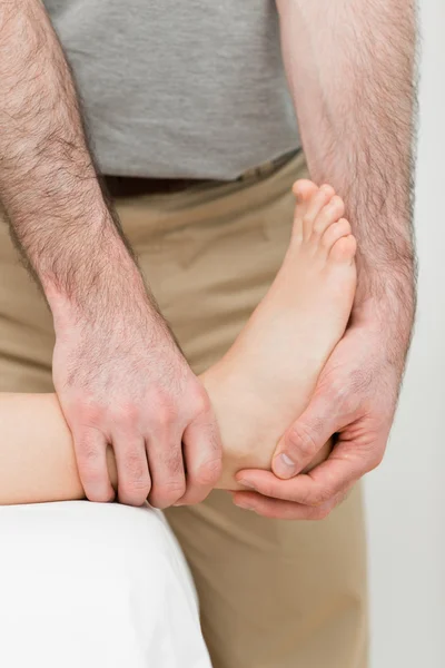 Foot being manipulated by a practitioner — Stock Photo, Image