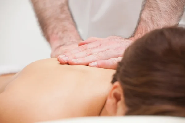 Close-up of a doctor massaging the back of a woman — Stock Photo, Image