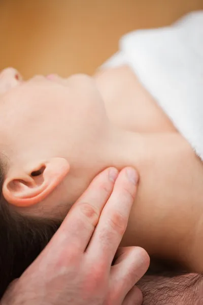 Close-up of doctor pressing two fingers on the neck of his patie — Stock Photo, Image