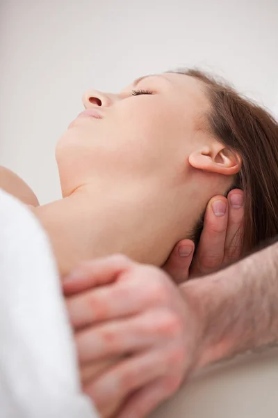 Close-up of neck of woman beig manipulating by a therapist — Stock Photo, Image