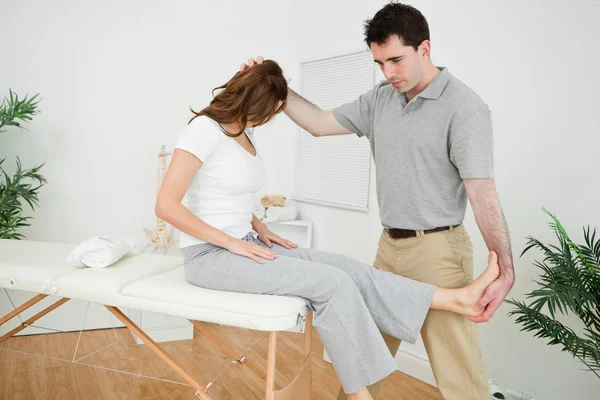 Physiotherapist manipulating his patient while standing — Stock Photo, Image
