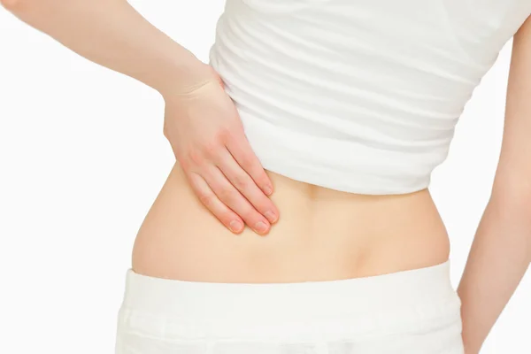 Close up of a woman massaging her back — Stock Photo, Image