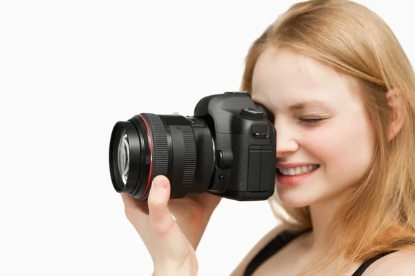 Smiling woman holding a camera — Stock Photo, Image