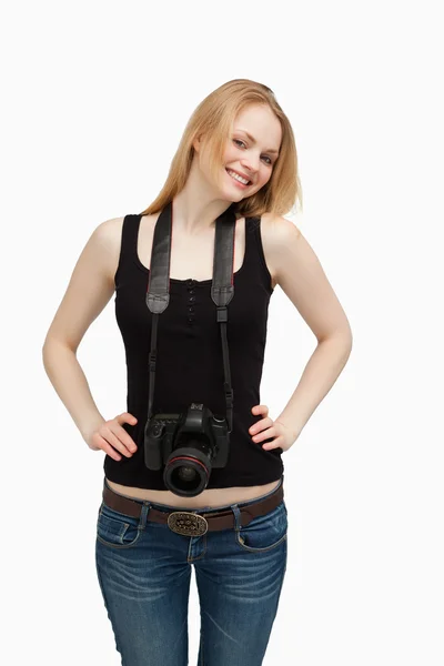 Smiling woman carrying a camera — Stock Photo, Image