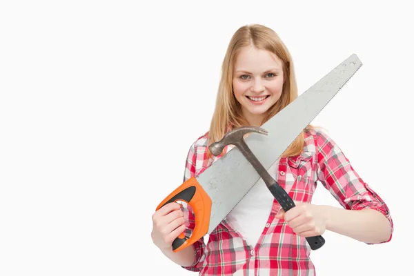 Woman holding a hammer and a saw — Stock Photo, Image